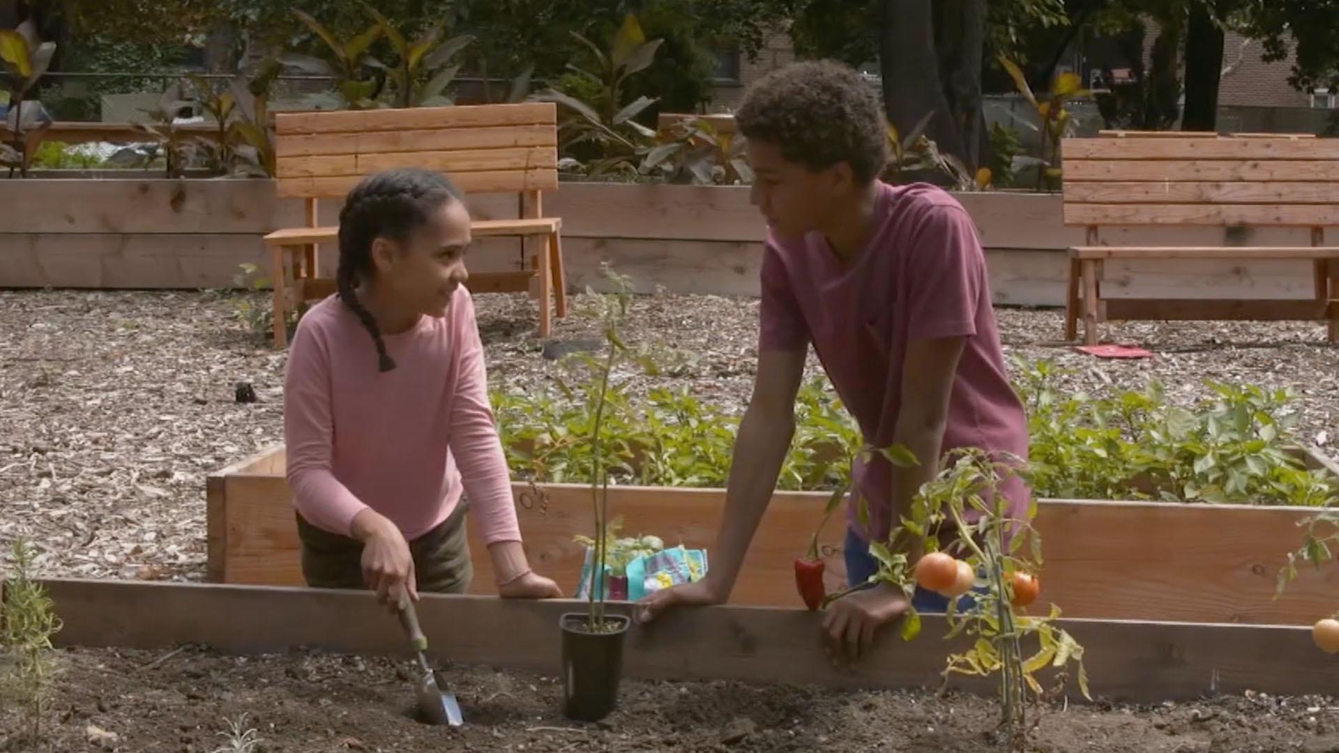 Jaden and Kimmie get "soily" at their local community garden