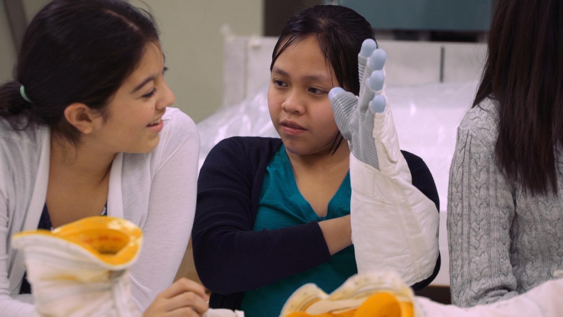 Alma Stephanie gives the SciGirls a tour of her spacesuit materials lab at NASA.
