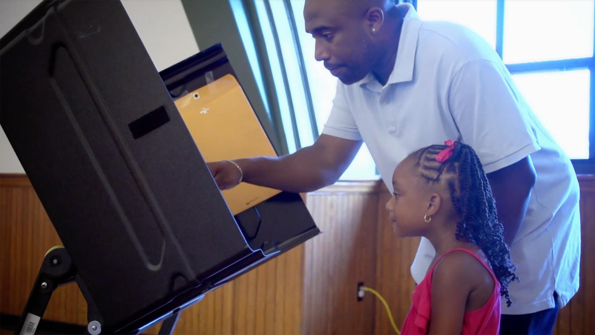 Mackenzie goes with her dad to vote in a real election.