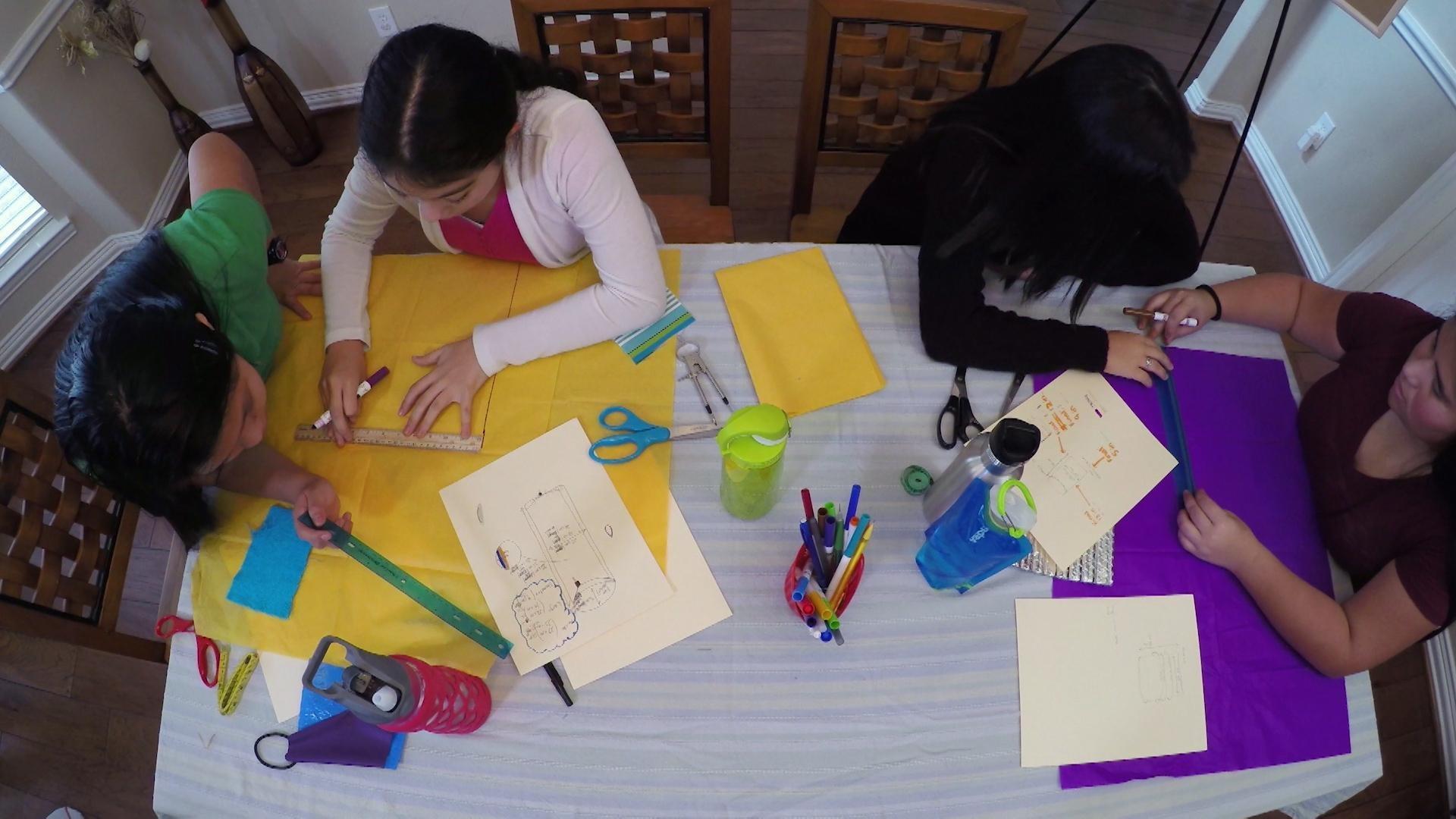 After testing materials, the SciGirls brainstorm to design the best water bottle carrier.