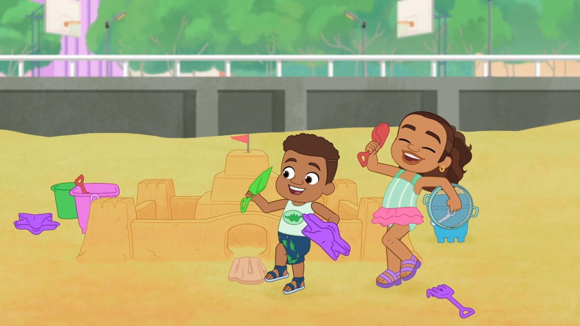 Alma and Junior each guard Junior's sandcastle, and Mami captures it with fun photos.