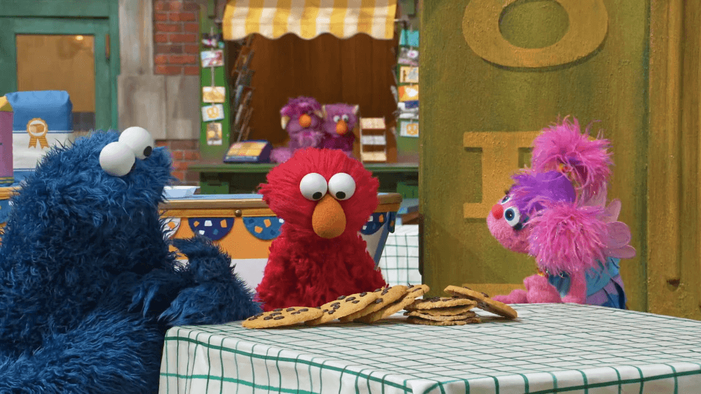 Elmo feels discouraged after knocking down the cookie tower. Abby and Cookie Monster help.