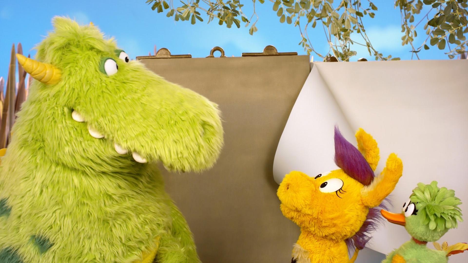 Stanley helps Donkey Hodie and Duck Duck read The Big Book of Rainbows.