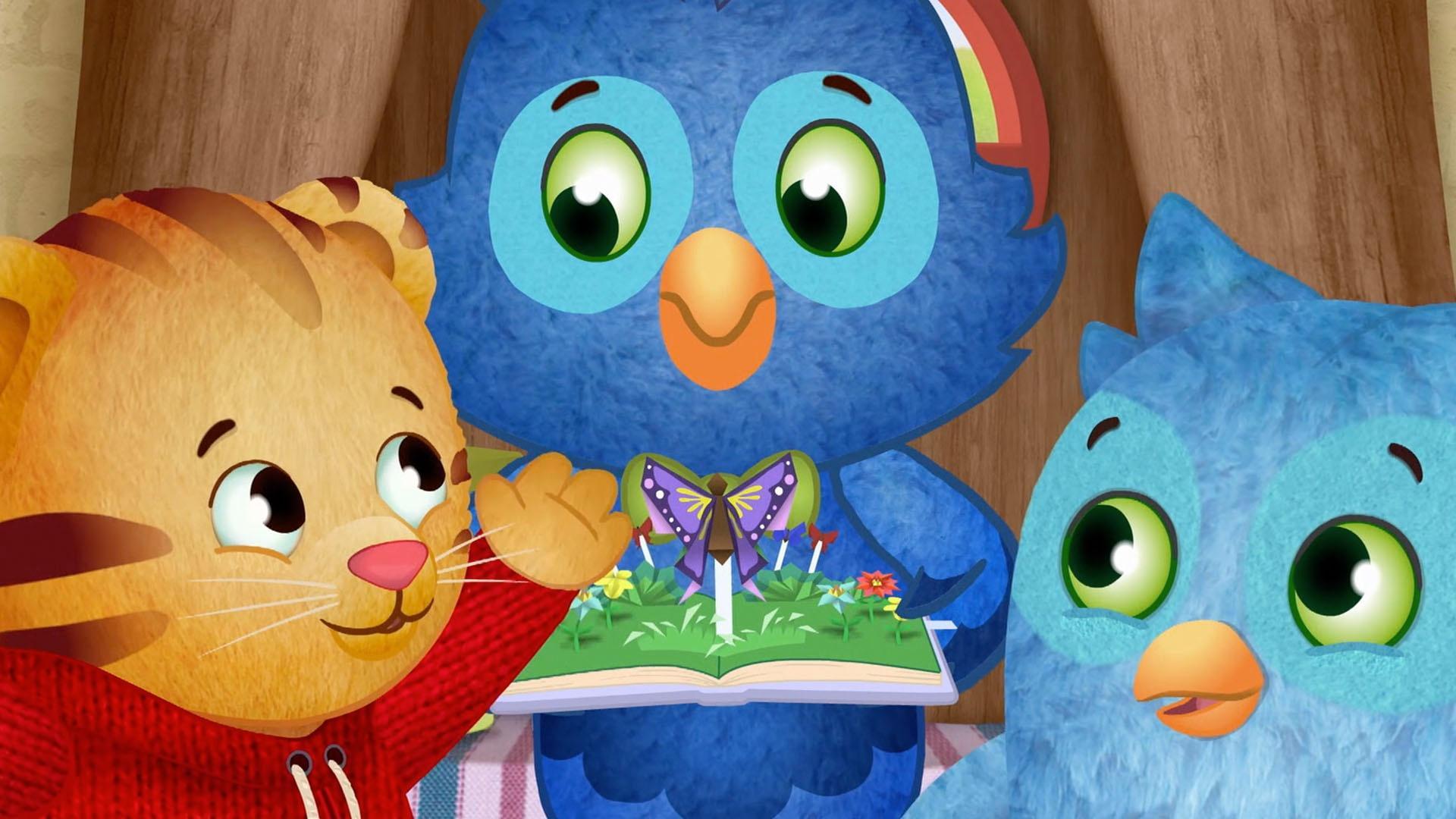 O and Daniel read the pop-up book with X.
