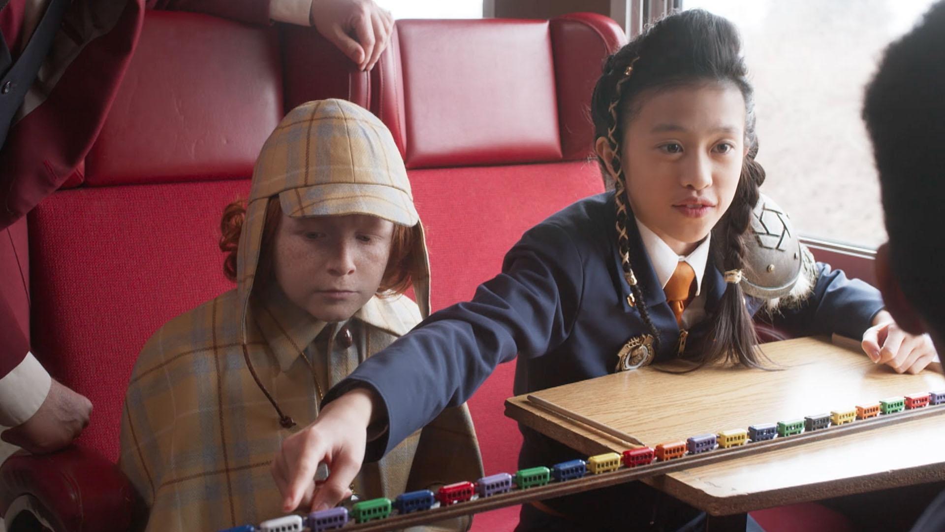 There’s a villain turning train cars odd. / Orla has an overdue library book.