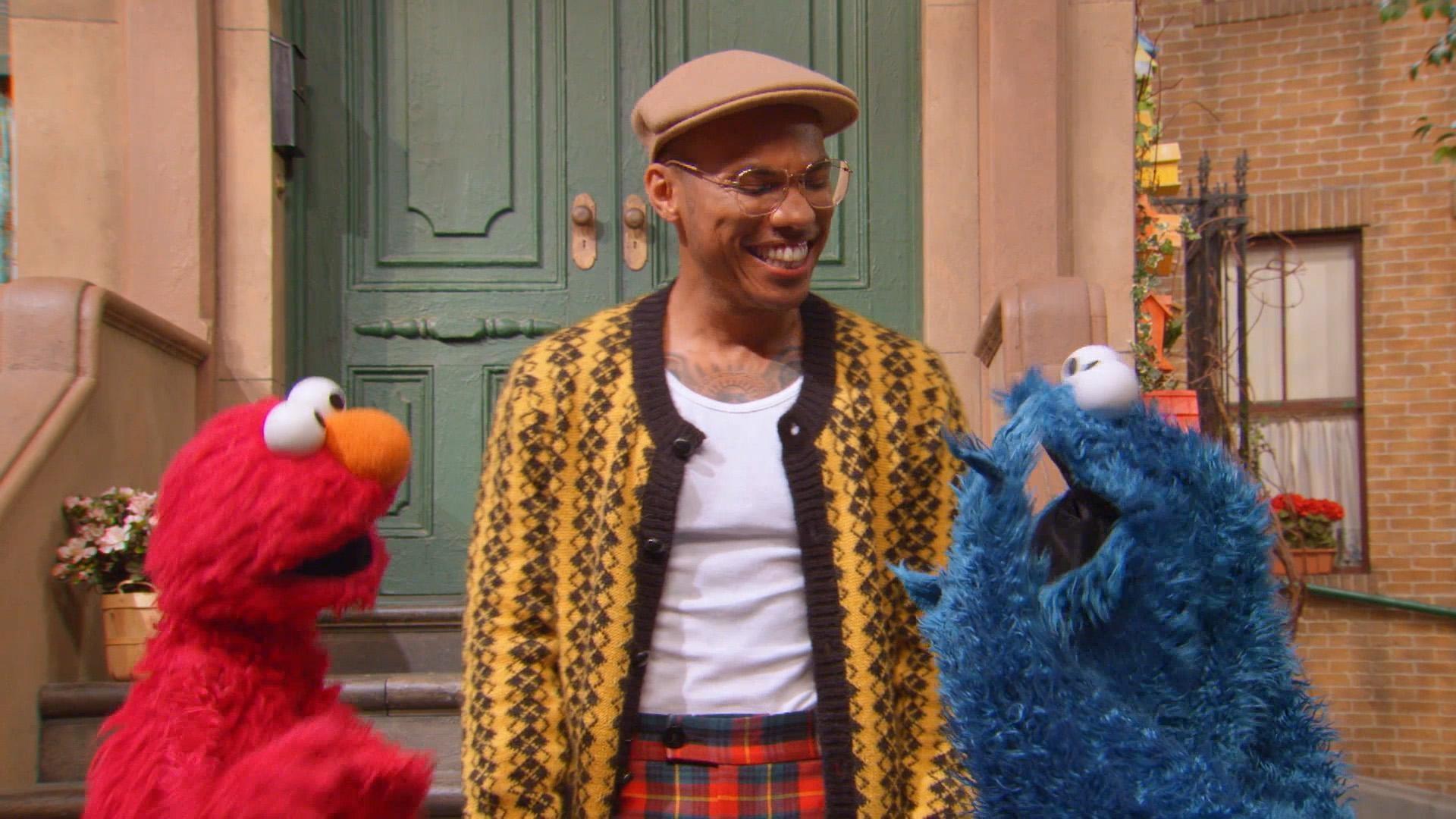 Anderson .PAAK explains what a holiday is to Cookie Monster and Elmo.