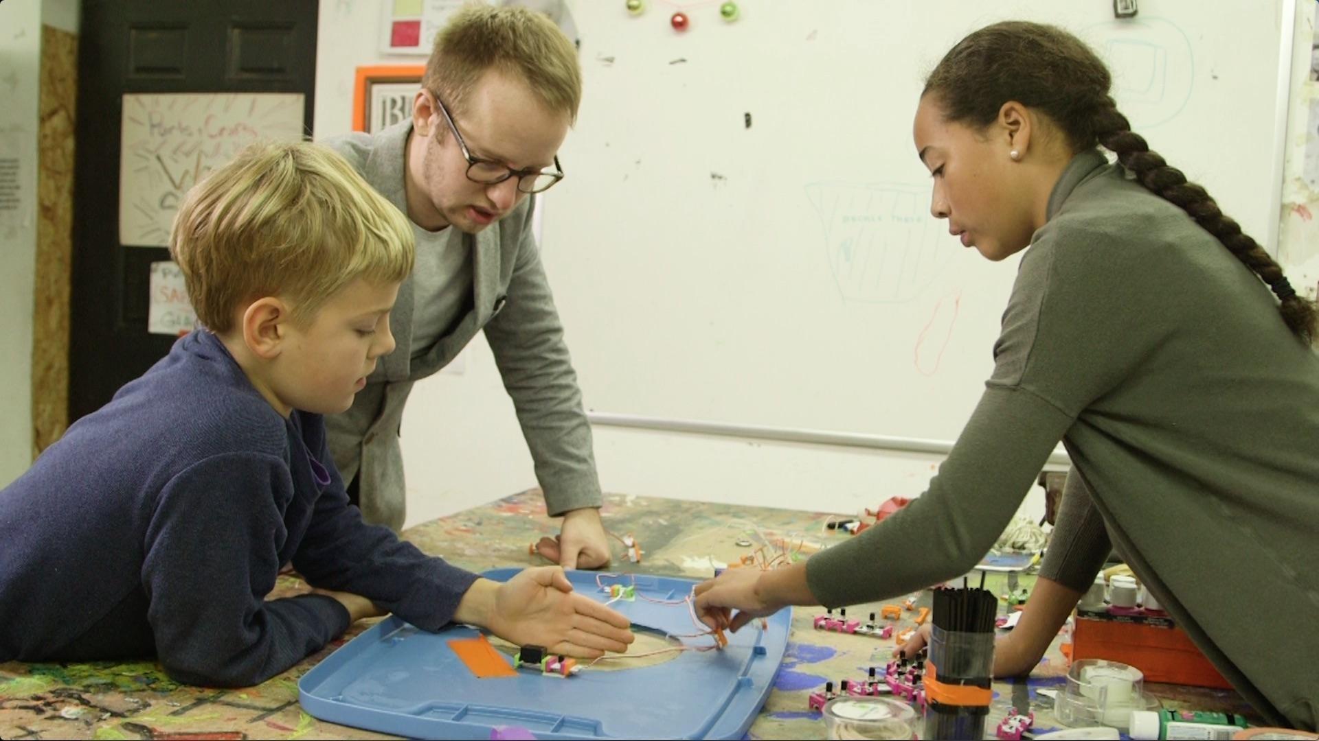 Kid engineers Grace and Aaron design and build a bin that encourages people to recycle.