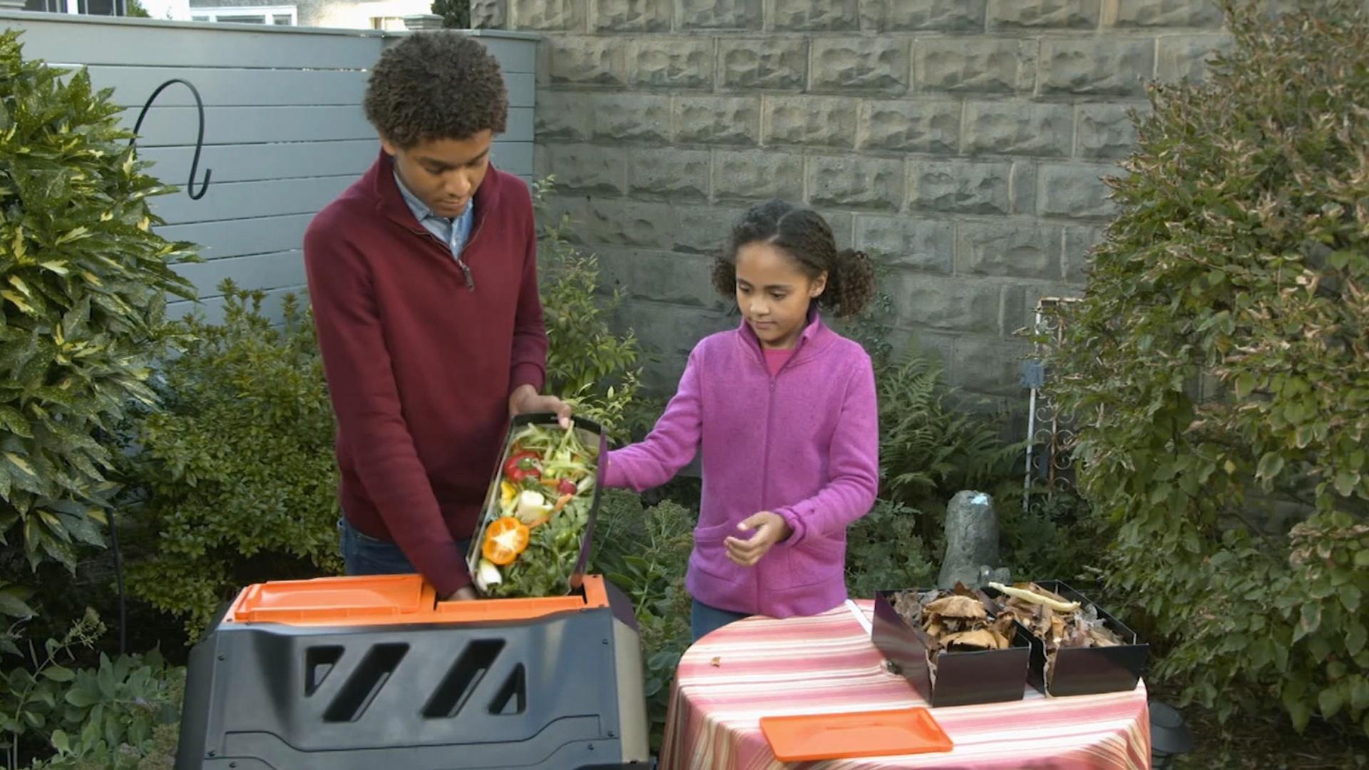 Jaden and Kimmie make a "salad" for their garden, turning food scraps into compost.