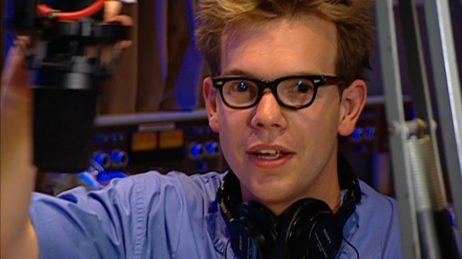 Harry plays songs and reads the news on the radio at different speeds to stay on schedule.