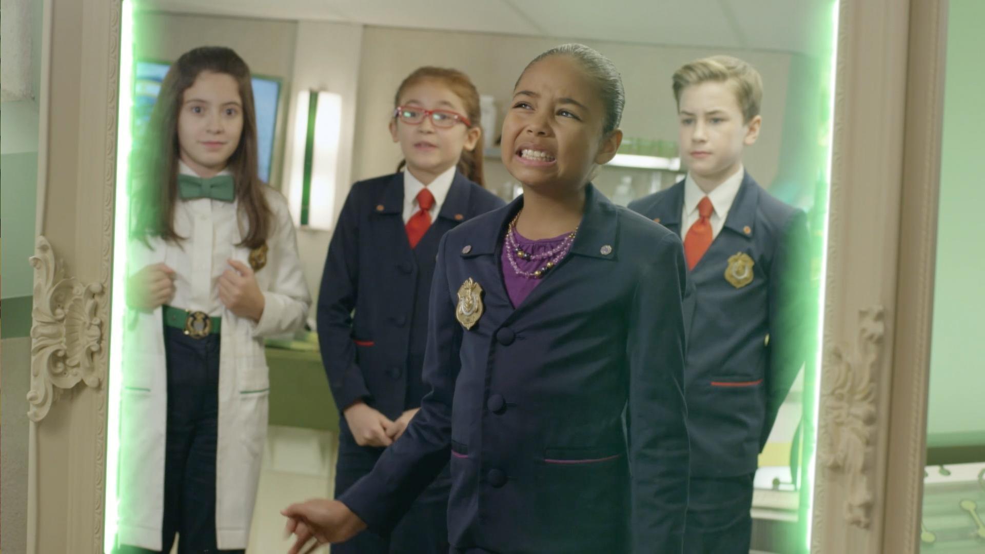 Ms. O gets trapped in a mirror. / The agents try to resolve a disagreement.