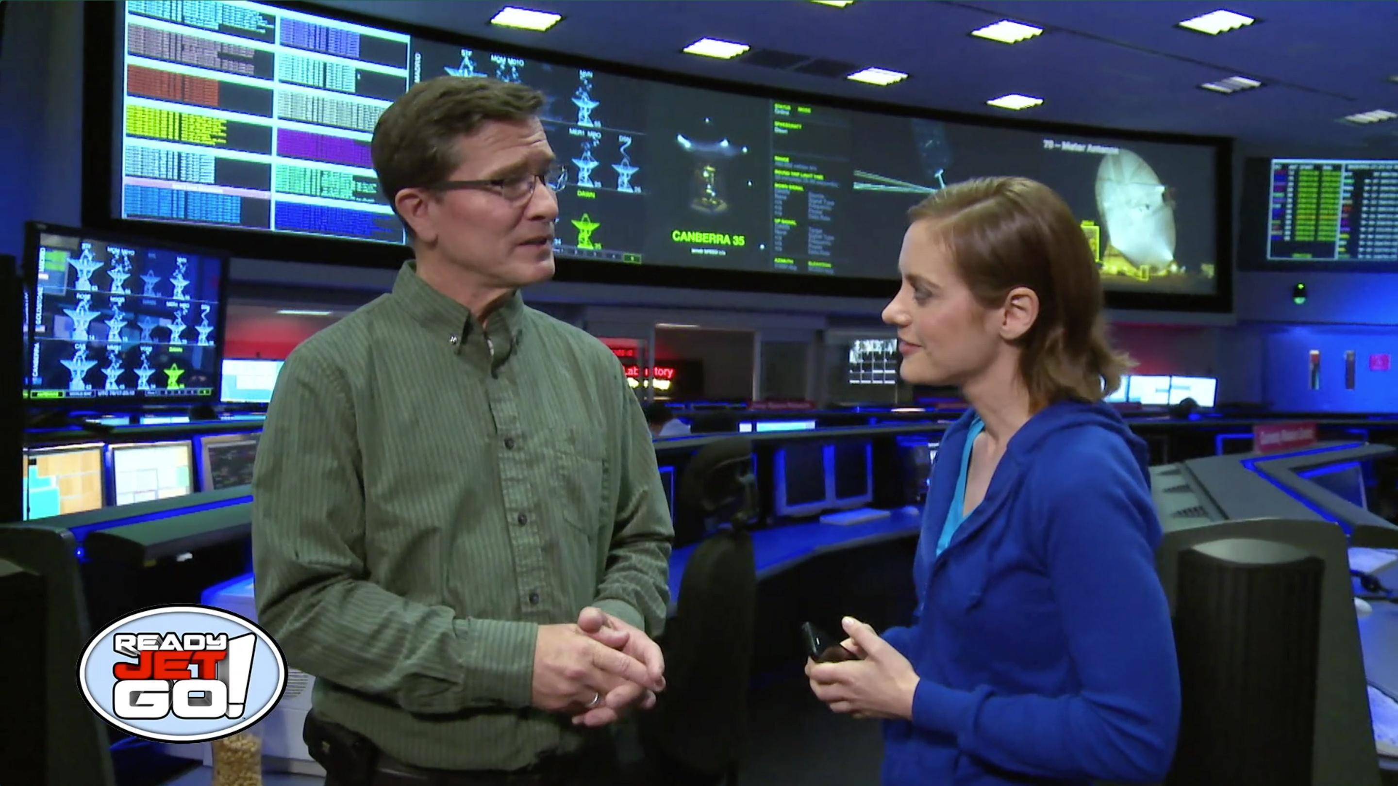 Astronomer Amy Mainzer meets with the operations manager at mission control.
