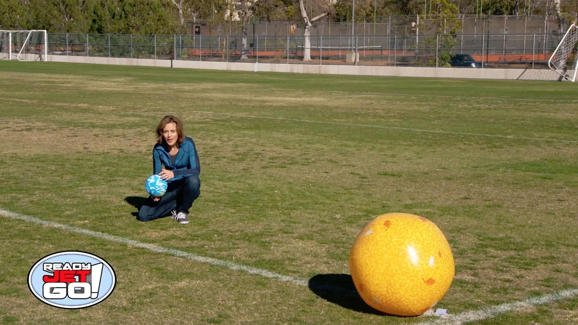 Amy Mainzer uses a soccer field to explain the distance of the planets to the sun.