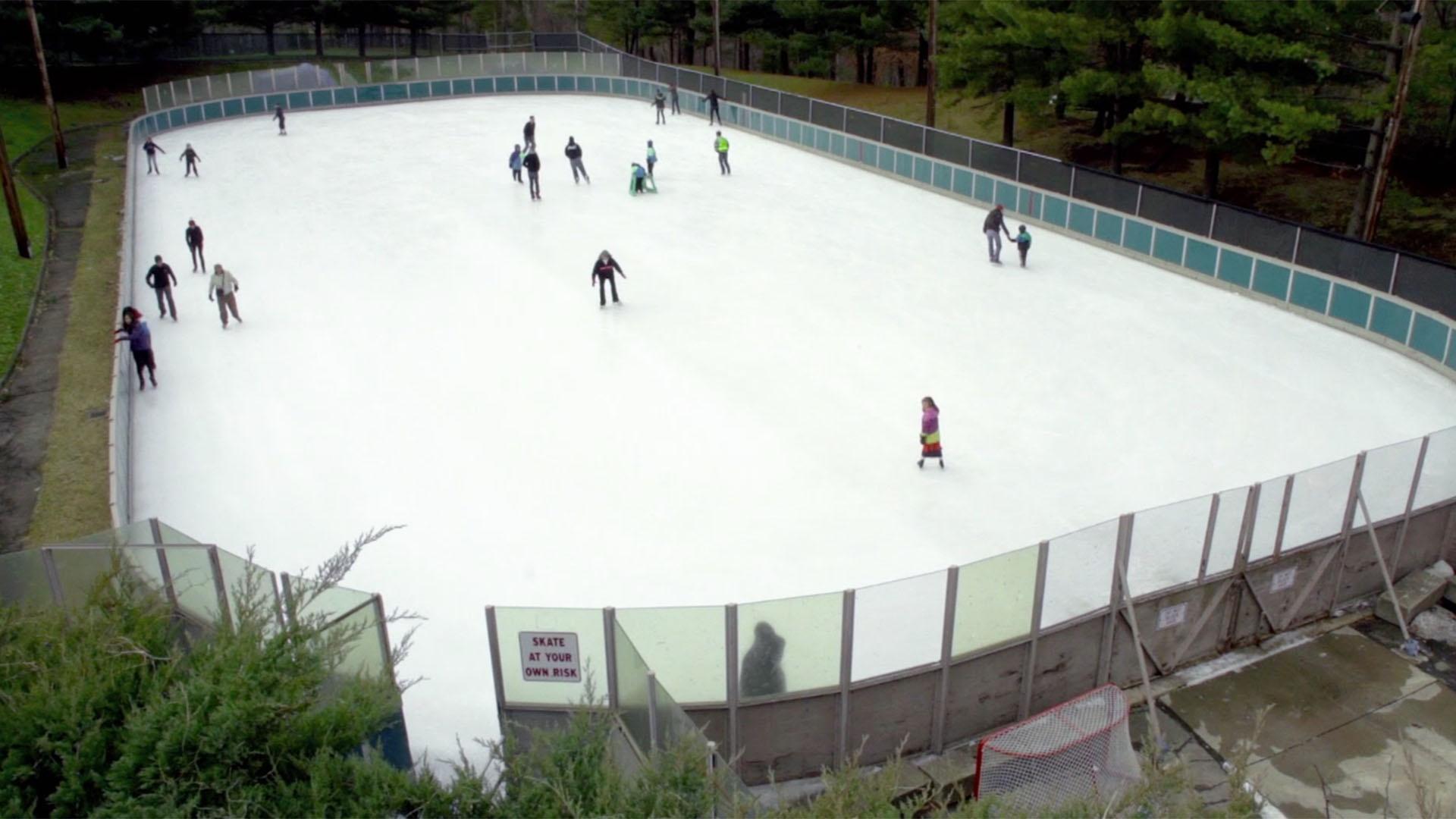 Calen's big brother shows Calen how to ice skate, little by little.