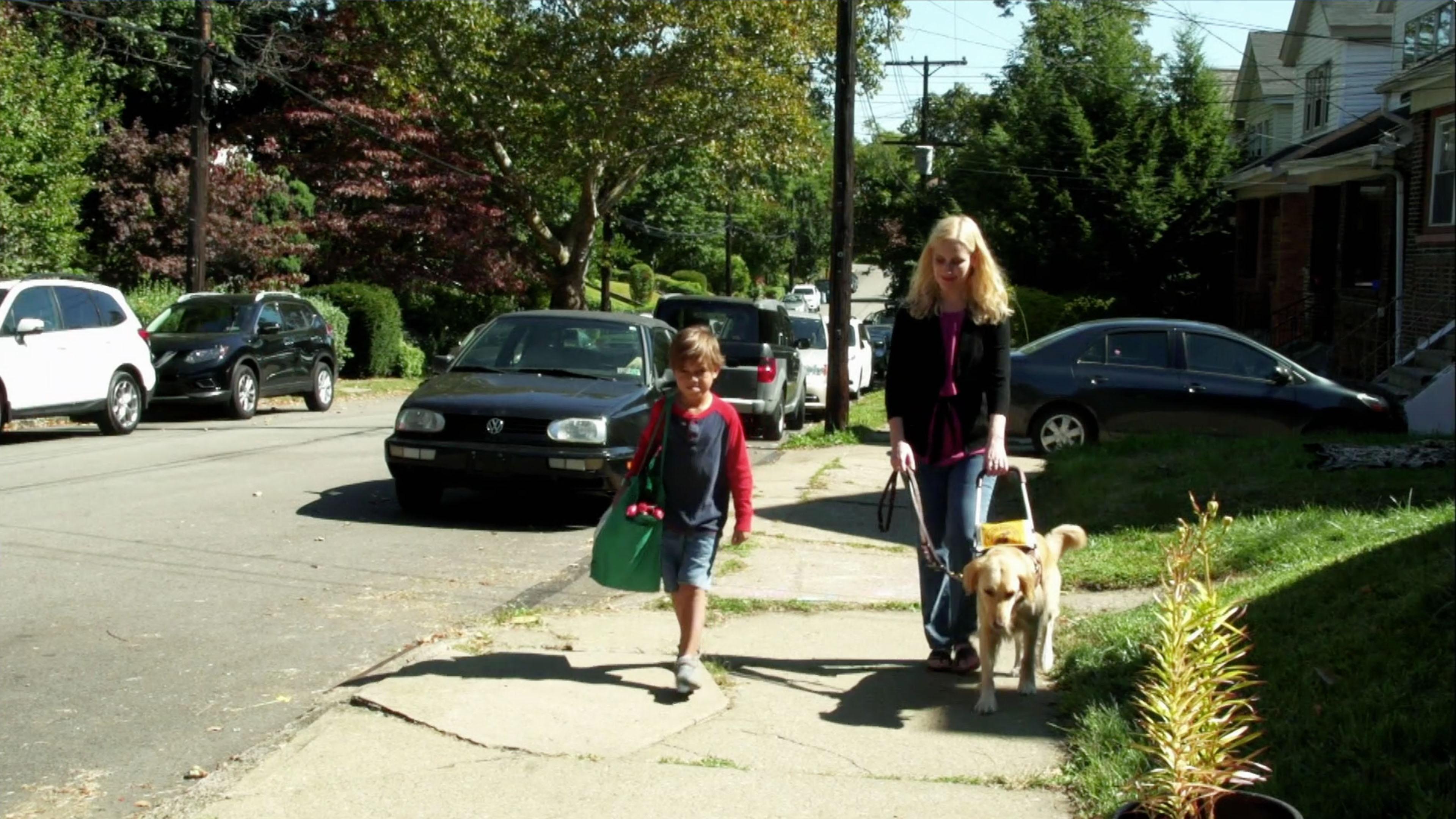 Tristan helps his neighbor Ann, who is blind, by carrying her groceries.