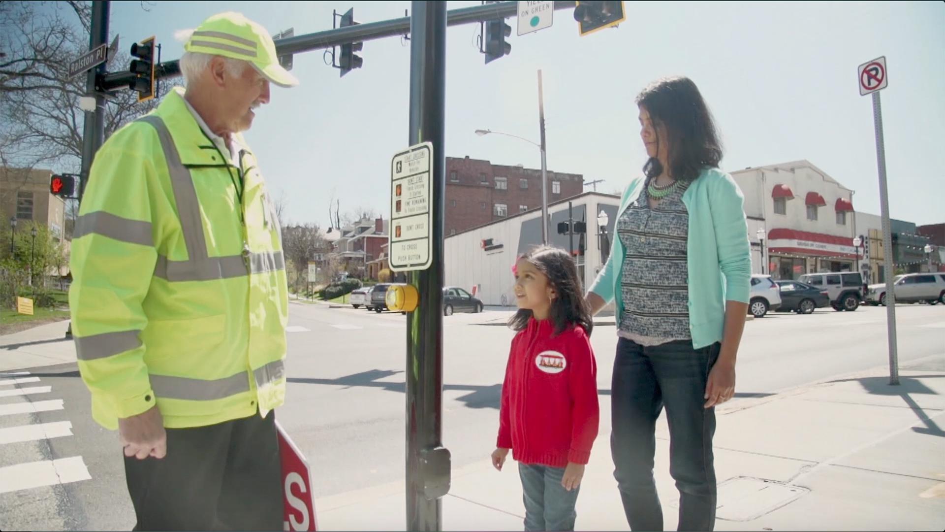 A crossing guard helps take care of children when they cross the street.