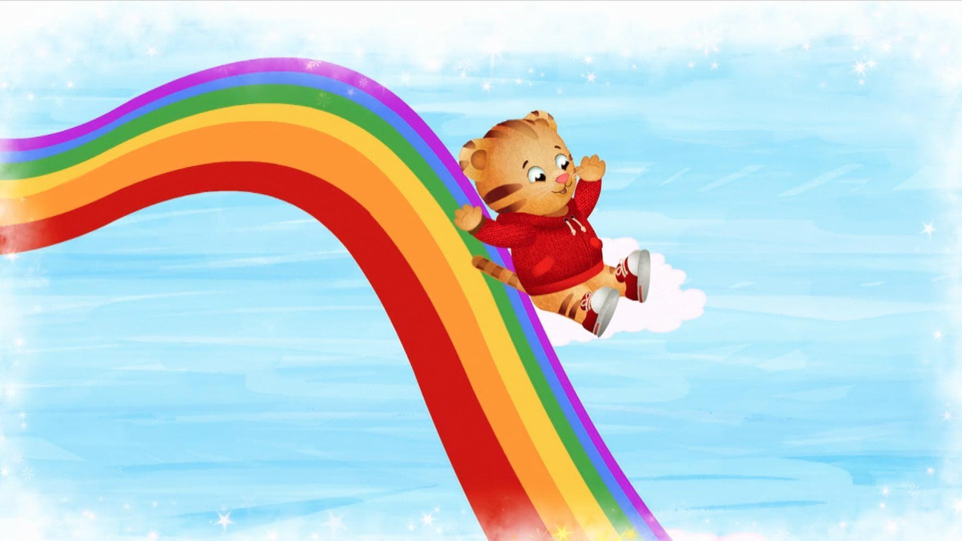 Daniel make believes he is a rainbow world where he slides down a giant rainbow.