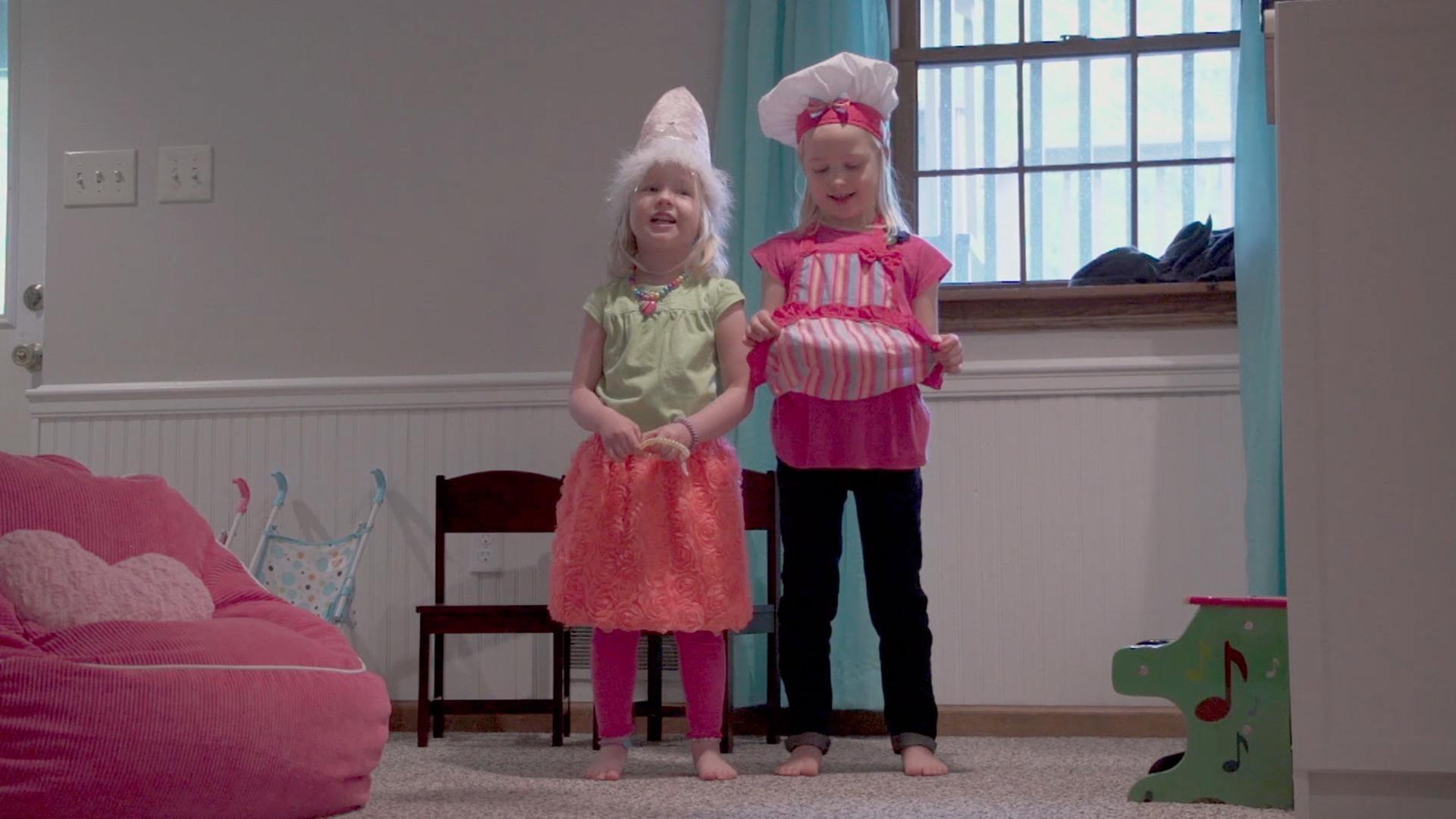 The sisters want to put on a show for Mom but both want to wear the same dress up clothes.