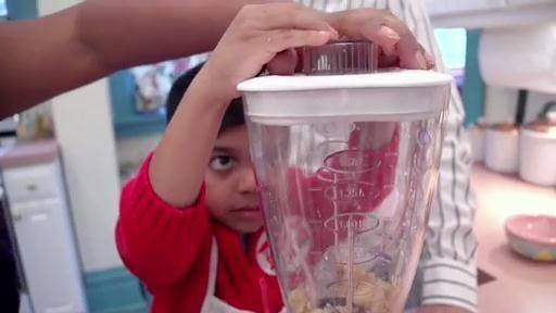With help from Mom and Dad, Roshan makes his own banana swirl.