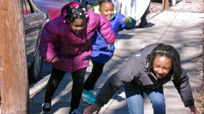 Three girls dodge sun
