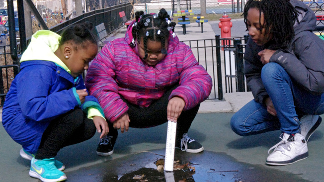 Girl measures puddle